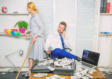 Female discrimination at workplace. Discrimination concept. Woman cleaning up office while boss counting money. Equal rights for education work and salary. Gender discrimination in business lifeの写真素材