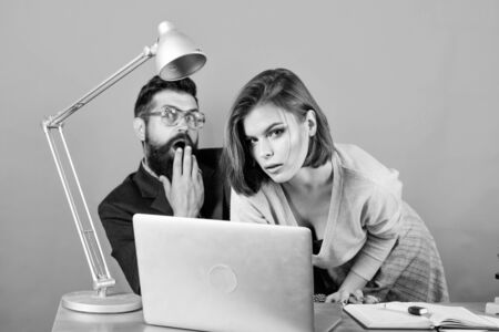 love affair at work. Seduction. business couple at computer. woman and man work in office at laptop. secretary with boss at workplace. businessman and assistant solve problem. Working on new tabletの写真素材