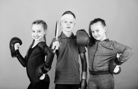 Ready to fight. Team sport success. workout of small girls boxer and boy in sportswear. Happy children in boxing gloves with tennis racket and ball. Fitness energy health. punching knockoutの写真素材