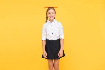 Hope for best. School girl studying textbook. Kid school uniform hold book. Life balance positivity. Dealing with school stress. Practice meditation. Find balance. Harmony concept. Peace and balanceの写真素材