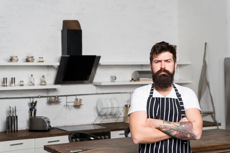 Best chef ever. bearded man hipster in kitchen. brutal man in cook apron. mature male with beard cooking. culinary business. tasty cuisine. serious and confident chef in restaurant. Culinary expertの写真素材