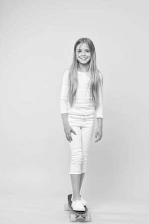 A pretty good skater girl. Cute small girl standing on skateboardの写真素材