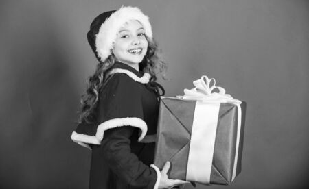 Unpacking christmas gift. Winter holiday tradition. Opening christmas gift. Kid happy with christmas present. Dreams come true. Girl celebrate christmas open gift box. Happy new year conceptの写真素材