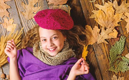 Autumn fashion accessory concept. Fashion trend fall season. Girl lay wooden background fallen...