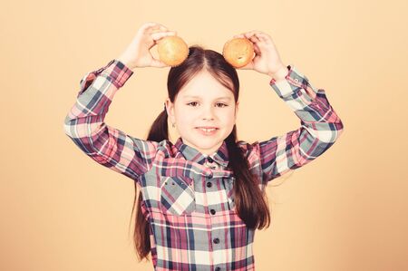 Diet healthy nutrition and calorie. Yummy muffins. Girl cute child eating muffins or cupcake. Sweet dessert. Culinary recipe. Tasty snack. Kid in love with muffins. Obsessed with homemade foodの写真素材
