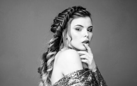 French braid. Professional hair care and creating hairstyle. Braided hairstyle. Beautiful young woman with modern hairstyle. Beauty salon hairdresser art. Girl makeup face braided long hairの写真素材