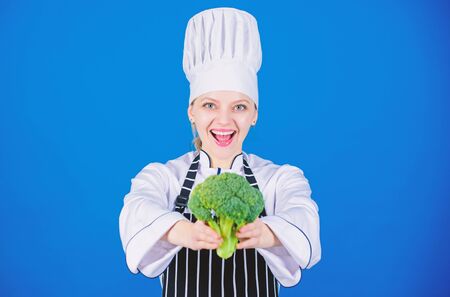 You never tasted broccoli like this. Lady cook smiling with organic broccoli plant. Happy woman holding fresh green broccoli crop. Professional chef with vitamin broccoli cabbageの写真素材
