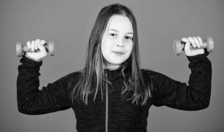 Deep squat. Happy child sportsman with barbell. workout of small girl hold dumbbell. weight lifting for muscules. Childhood activity. Fitness diet for energy health. Sport success. One more squatの写真素材