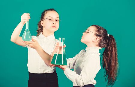 children study chemistry lab. back to school. biology education. little smart girls with testing flask. school kid scientist studying science. Bright minds at work. laboratory work. school work placeの写真素材