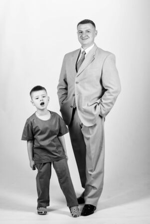 Doctor respectable career. Dad boss. Father and cute small son. Child care development upbringing. Respectable profession. Family business. Man respectable businessman and little kid doctor uniformの写真素材
