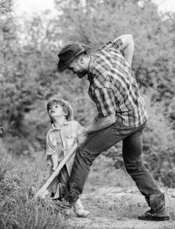 Happy childhood. Adventure hunting for treasures. Little helper working in garden. Cute child in nature having fun with shovel. Find treasures. Little boy and father with shovel looking for treasuresの写真素材