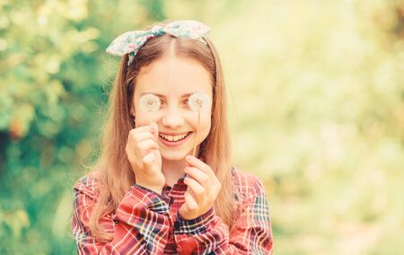 Natural beauty. Childhood happiness. little girl and with taraxacum flower. happy child hold blowball. dandelion. Spring holiday. Womens day. summer vacation. Rancho and country. Gardeningの写真素材