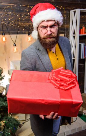 Man santa hat deliver gift. Spread happiness and joy. Bearded guy with eyeglasses carry present box....