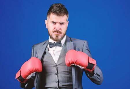 Inspired to work hard. knockout and energy. Fight. bearded man in boxing gloves punching. powerful man boxer ready for corporate battle. businessman in formal suit and tie. Business and sport successの写真素材