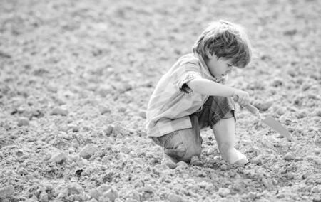 farming and agriculture. small kid planting a flower. ecology life. Cultivation concept. earth day....