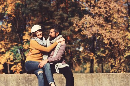 Man and woman with cheerful faces on autumn trees backgroundの写真素材