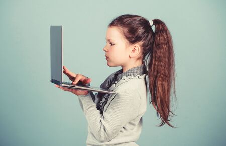 online courses private teaching. child development in digital age. Weblog in virtual world. online shopping blog. business digital marketing. happy small girl blogging on laptop. Happy studentの写真素材