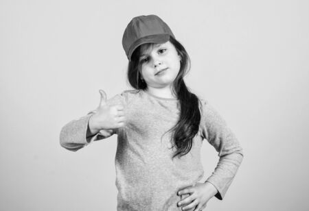 Thumbs up if you feel beautiful. Adorable girl showing approval hand gesture. Cute small child...
