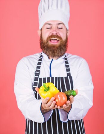 Choose vegetarian lifestyle. Man cook hat apron hold fresh vegetables. Buy fresh vegetables grocery store. Vegetarian restaurant. Hipster chief chef vegetarian cafe. Vegetarian recipe conceptの写真素材