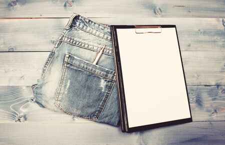 Psychoanalysis concept. Medical insurance. Paper tablet and pen on jeans background copy space. History of the disease. Medical treatment. Medical help and consultation. Interviewing patient.の写真素材