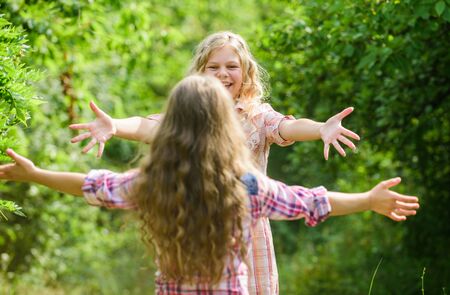 finally met. girls friends meet in green forest. summer vacation. childrens day. happy little girls with long healthy hair. hair health and care. hairdresser fashion and beauty. long curly hairの写真素材