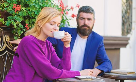 Casual meet acquaintance public place. Meeting people first date. Strangers meet become acquaintances. Apps normal way to meet and connect with other single people. Couple terrace drinking coffeeの写真素材