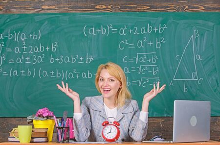 Punctuality is a way to success. teacher with alarm clock. Time. Study and education. Modern school....