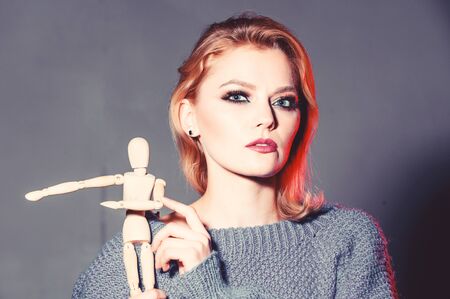 womens power. women rule the world. sexy woman with fashion makeup. wooden figure in hand of girl....