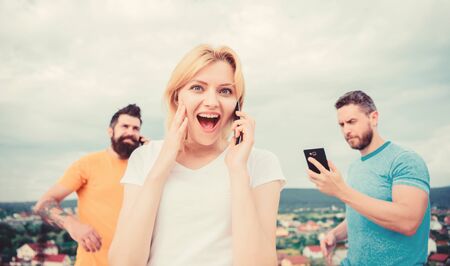 Close up of a group of young people with smartphones. Friends an