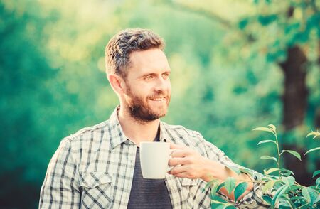 morning coffee. healthy lifestyle. nature and health. drink tea outdoor. ecological life for man. man in green forest. breakfast refreshment time. happy man with cup of tea. Good morning coffeeの写真素材