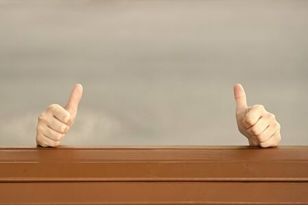 If you like it thumbs ups. Human hands giving thumbs ups sign on grey background. Extending hands...