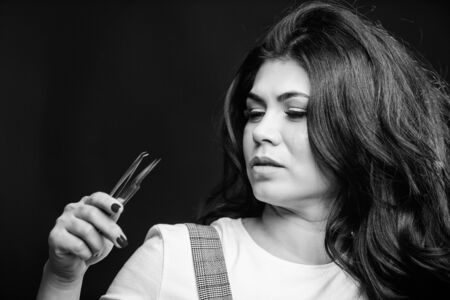 Makeup false lashes volume. Lash applicator. Professional eyelash extension tweezer. Makeup artist. Cosmetic tweezer. Beauty shop concept. Girl makeup face hold tweezer for eyelash extensionの写真素材