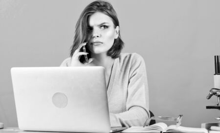 Woman with computer. businesswoman talking on phone. woman work in office at laptop. data and...