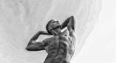 Man muscular chest torso stand sky background. Strong muscles emphasize masculinity sexuality. Bodybuilder shape. Sexy torso attractive body. Man muscular athlete bodybuilder show musclesの写真素材
