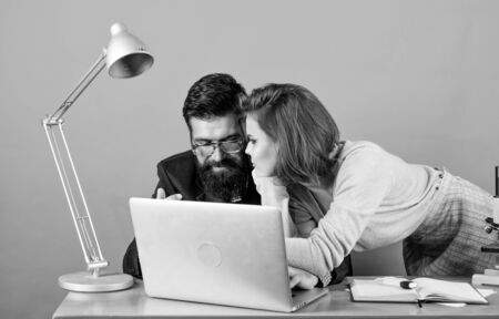 love affair at work. Seduction. business couple at computer. secretary with boss at workplace. woman...