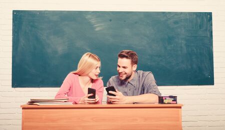 Look at this. Back to school. Couple of man and woman in classroom. Home schooling. Modern school....