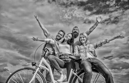 Freedom urban commuting. Bicycle as part of life. Cycling modernity and national culture. Group friends hang out with bicycle. Company stylish young people spend leisure outdoors sky backgroundの写真素材