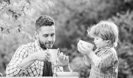 they love eating together. Weekend breakfast. father and son eat outdoor. small boy child with dad. healthy food. Family day bonding. organic and natural food. Happy family togetherの写真素材