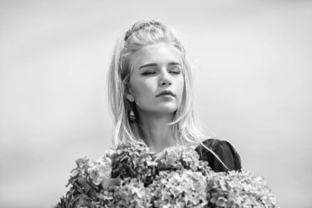 Skin care and beauty treatment. Springtime bloom. Gentle flowers for delicate woman. Pure beauty. Tenderness of young skin. Beauty of spring season. Girl tender blonde hold hydrangea bouquetの写真素材