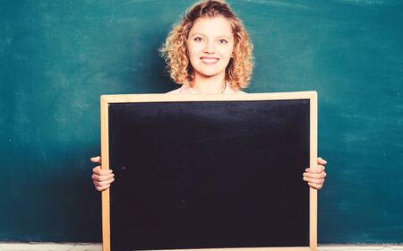 Well Done is Our Duty. woman teacher at blackboard. copy space. here is your advertisement....
