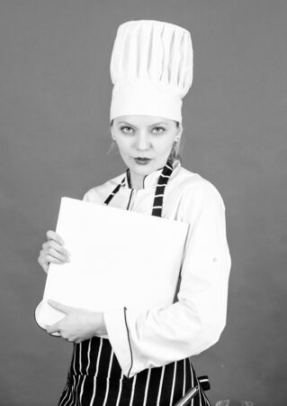 Housewife with cookery book. professional chef in kitchen. Cuisine. restaurant menu. Culinary dieting. woman in cook hat and apron. sexy woman cooking healthy food by recipe. you are what you eatの写真素材