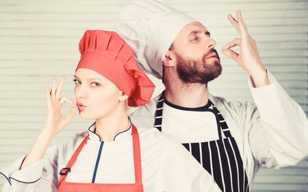 Delicious family dinner. Cooking with your spouse can strengthen relationships. Reasons couples cooking together. Teamwork in kitchen. Couple cooking dinner. Woman and bearded man culinary partnersの写真素材