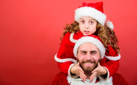 Girl little cute child and bearded father wear santa costume. Christmas party. How to be santa claus parents guide. My dad is santa claus. Belief in santa constitutes most magical part of childhoodの写真素材