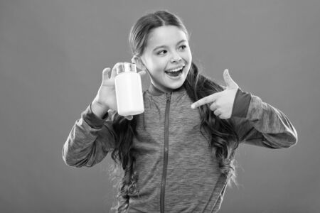 Need vitamin supplements. Child cute girl take some medicines. Treatment and medicine. Natural product. Childrens multivitamins. Take vitamin supplements. Girl hold medicines bottle. Vitamin conceptの写真素材