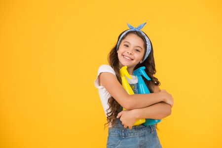 Cleaning products that work. Happy little girl enjoy doing house work. Cute small child ready for cleaning work. Clean home is our work, copy spaceの写真素材