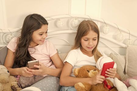 Girlish leisure happy childhood. Girls with smartphone use modern technology. Lets take selfie. Send...