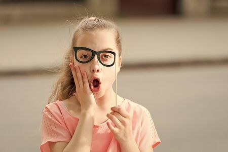 Pamper your skin with natural treats. Small child with healthy skin and funny look through prop glasses. Cute little girl with soft baby skin on surprised face. Childrens skin care cosmeticsの写真素材