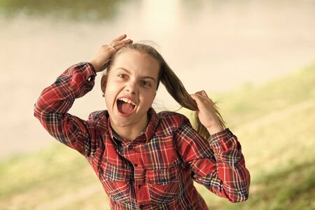 Deal with long hair on windy day. Windproof hairstyles. Girl little cute child enjoy walk on windy day nature background. Hairstyles to wear on windy days. Feeling cozy and comfortable on windy dayの写真素材