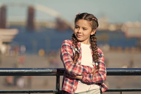 Sunny day walk. Leisure options. Free time and leisure. Girl cute kid with braids relaxing urban background defocused. Organize activities for teenagers. Vacation and leisure. What do on holidaysの写真素材
