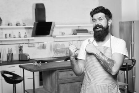 Home food. Recommend nice recipe. Culinary business. Brutal confident chef in restaurant. Hipster bearded masculine chef cooking food in kitchen. Cuisine for real men. Cooking tasty food at homeの写真素材